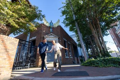 A man and woman hold hands as they explore Winston-Salem's downtown arts district.
