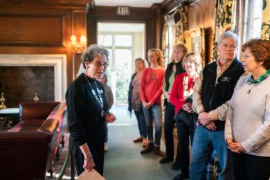 A docent stops to explain an exhibit in the Reynolda House Museum of American Art while leading a group tour.