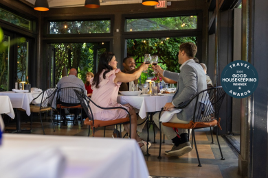 Four diners clink their wine glasses while enjoying a meal at Bernardin's Restaurant in Winston-Salem.