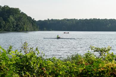 Two kayaks can be seen from the shore of Salem Lake, gliding across the water on a sunny day.