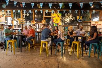 A group of people enjoy drinks at Wise Man Brewing in Winston-Salem