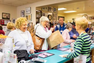 Two women stop to purchase some cookies while on a motorcoach tour at Mrs. Hanes Cookie Factory near Winston-Salem, North Carolina.