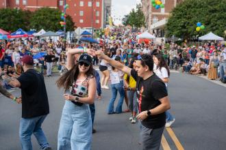 A group of couples dance in the street during the Hispanic League Fiesta street festival in Winston-Salem, North Carolina.