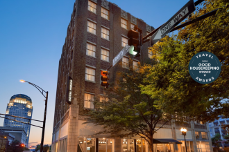 Hotel Indigo, located on Liberty Street in Winston-Salem, sits in focus among the nighttime downtown skyline.