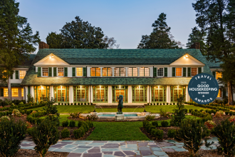 An exterior shot of the Reynolda House Museum of American Art, with a sculptural fountain sitting at the middle.