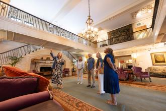 A tour group stops to admire the great room at the Reynolda House Museum of American Art.