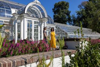 Two women exit the conservatory at Reynolda Gardens in Winston-Salem