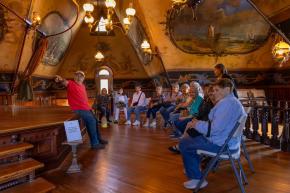 A tour group admires and learns about the unique design and architecture in the theatre of Korners Folly.