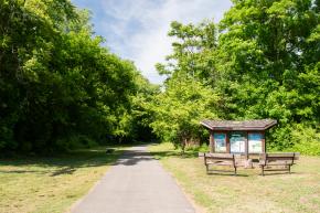 Signage for the Gateway Nature Preserve with a park entrance along the path of the Salem Creek Greenway Trail.