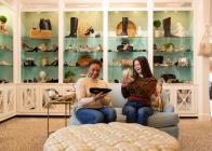 Two women admire shoes inside of Monkees of the Village Boutique in Reynolda Village Shopping Center.